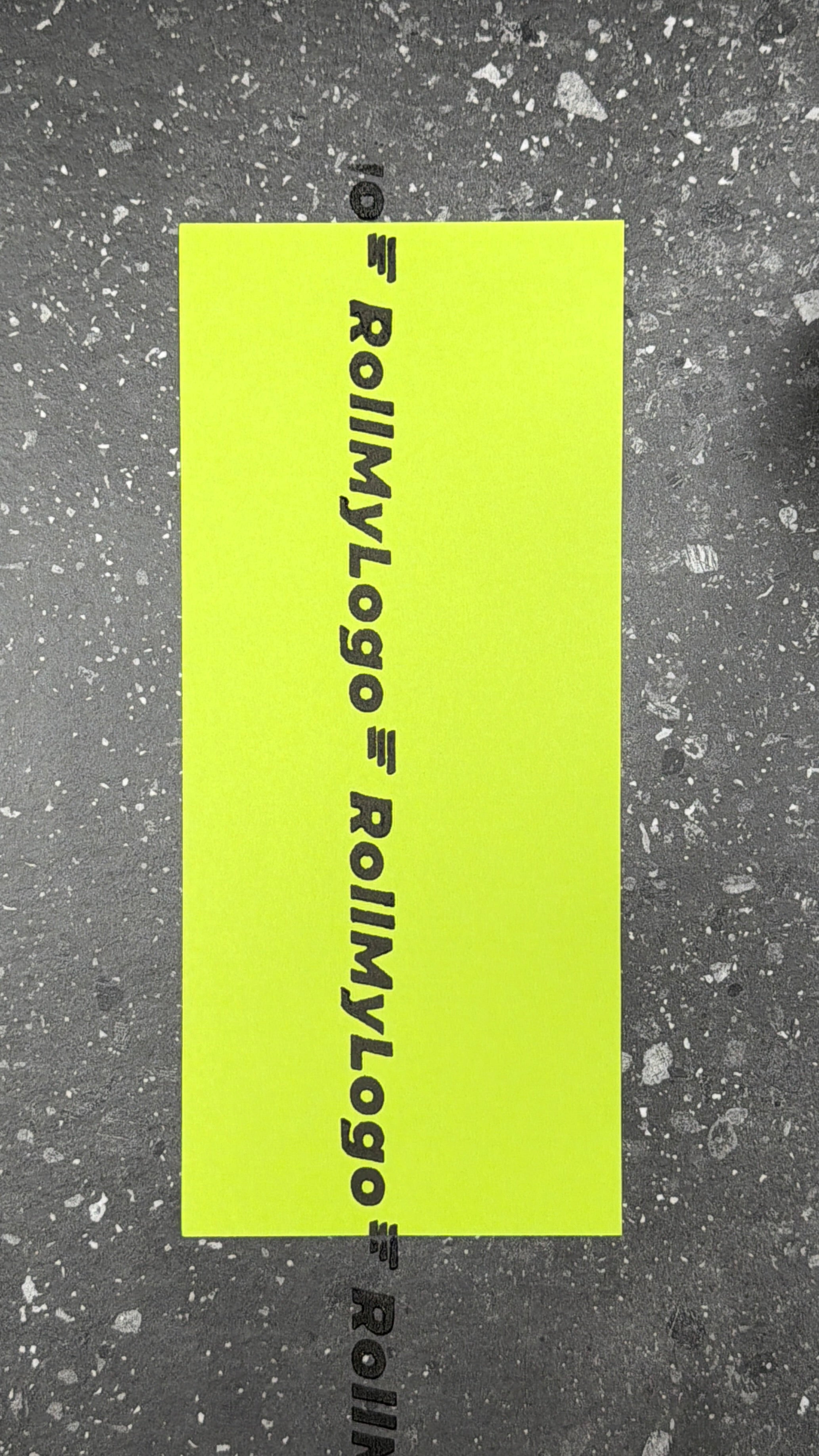 Real RollMyLogo rolling imprint on bright green paper